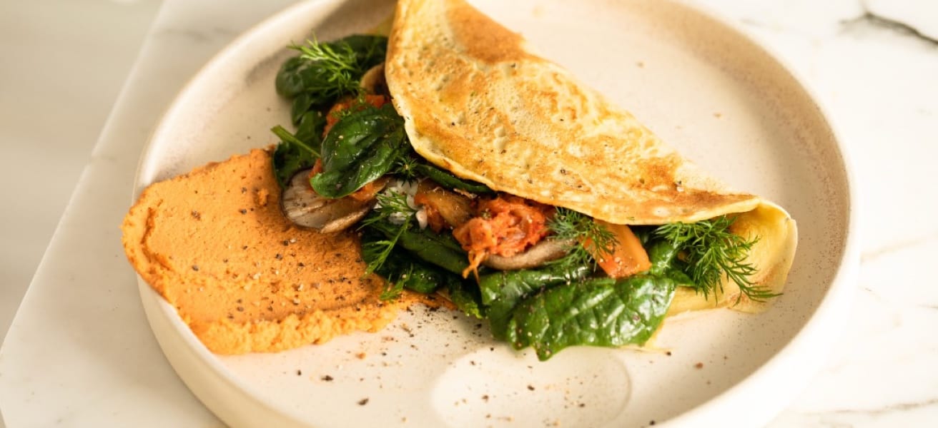 Delicious omelette filled with spinach and tomatoes